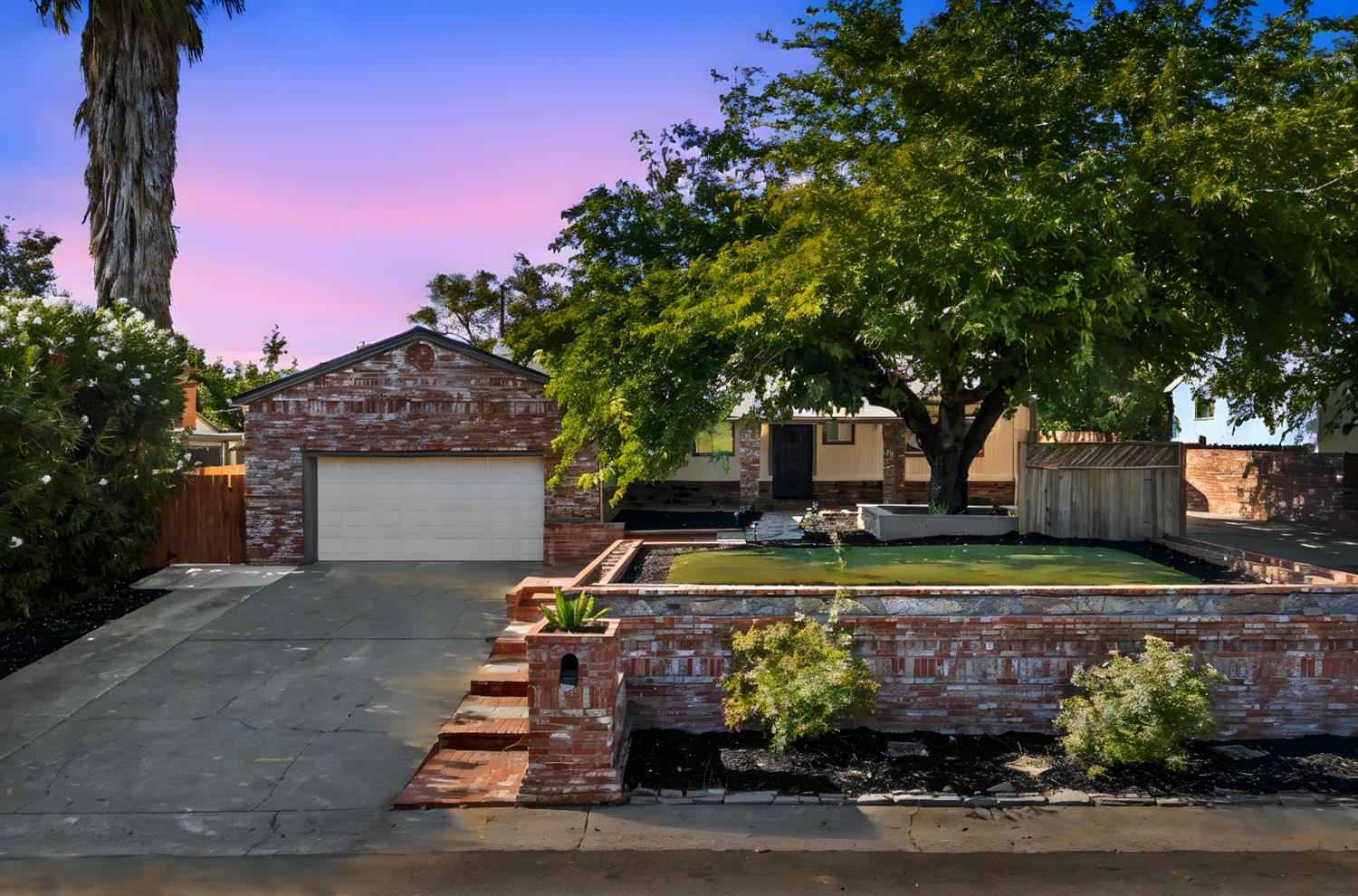 Frontage of the Fair Oaks property at dusk after renovation